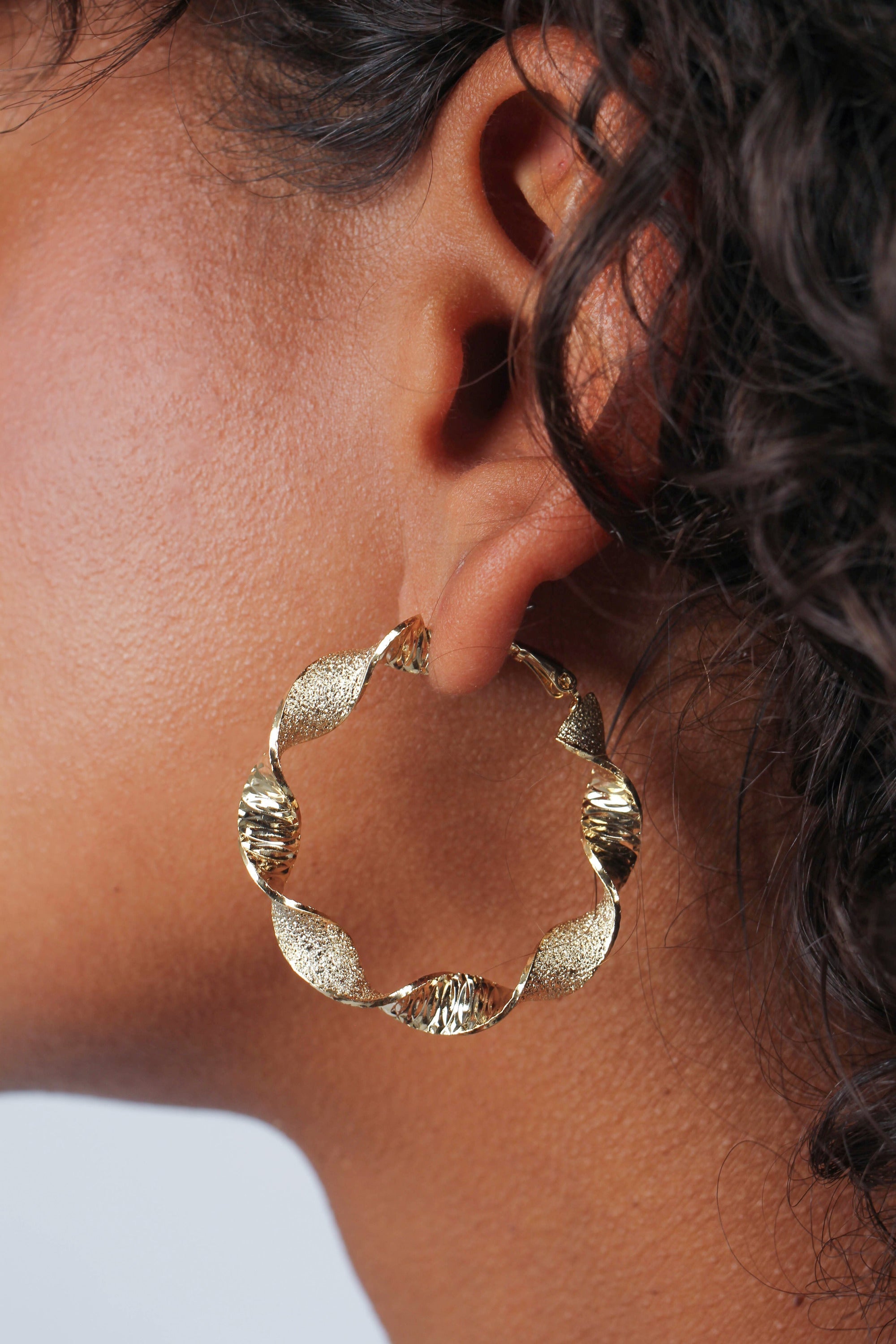 Gold rough smooth twisted hoop earrings
