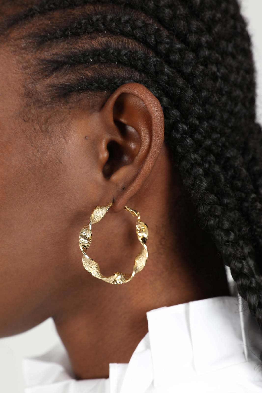 Gold rough smooth twisted hoop earrings