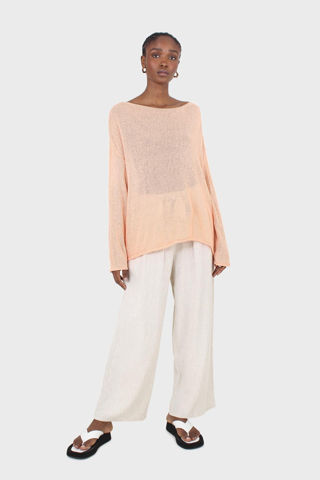 Pale orange wide neck long sleeved loose knit top