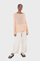 Pale orange wide neck long sleeved loose knit top