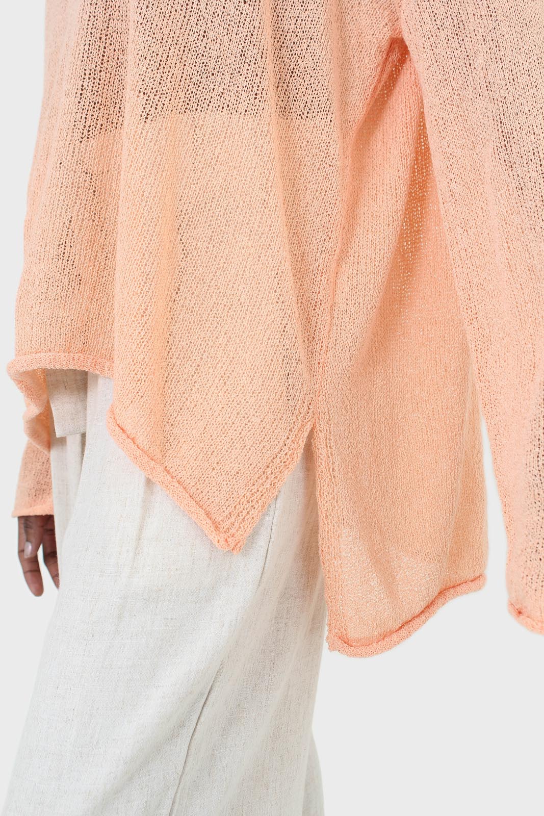 Pale orange wide neck long sleeved loose knit top