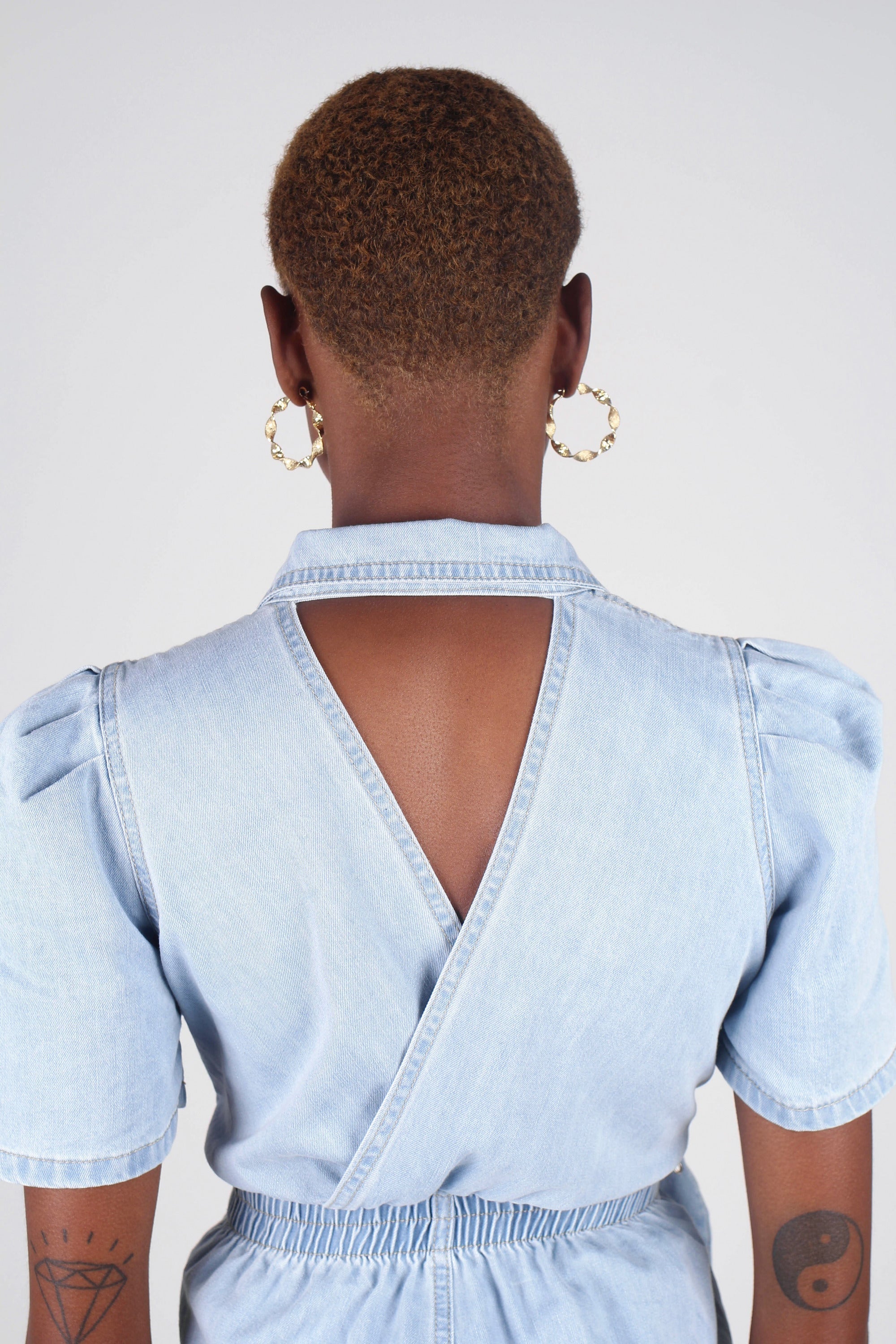 Light blue denim open back romper