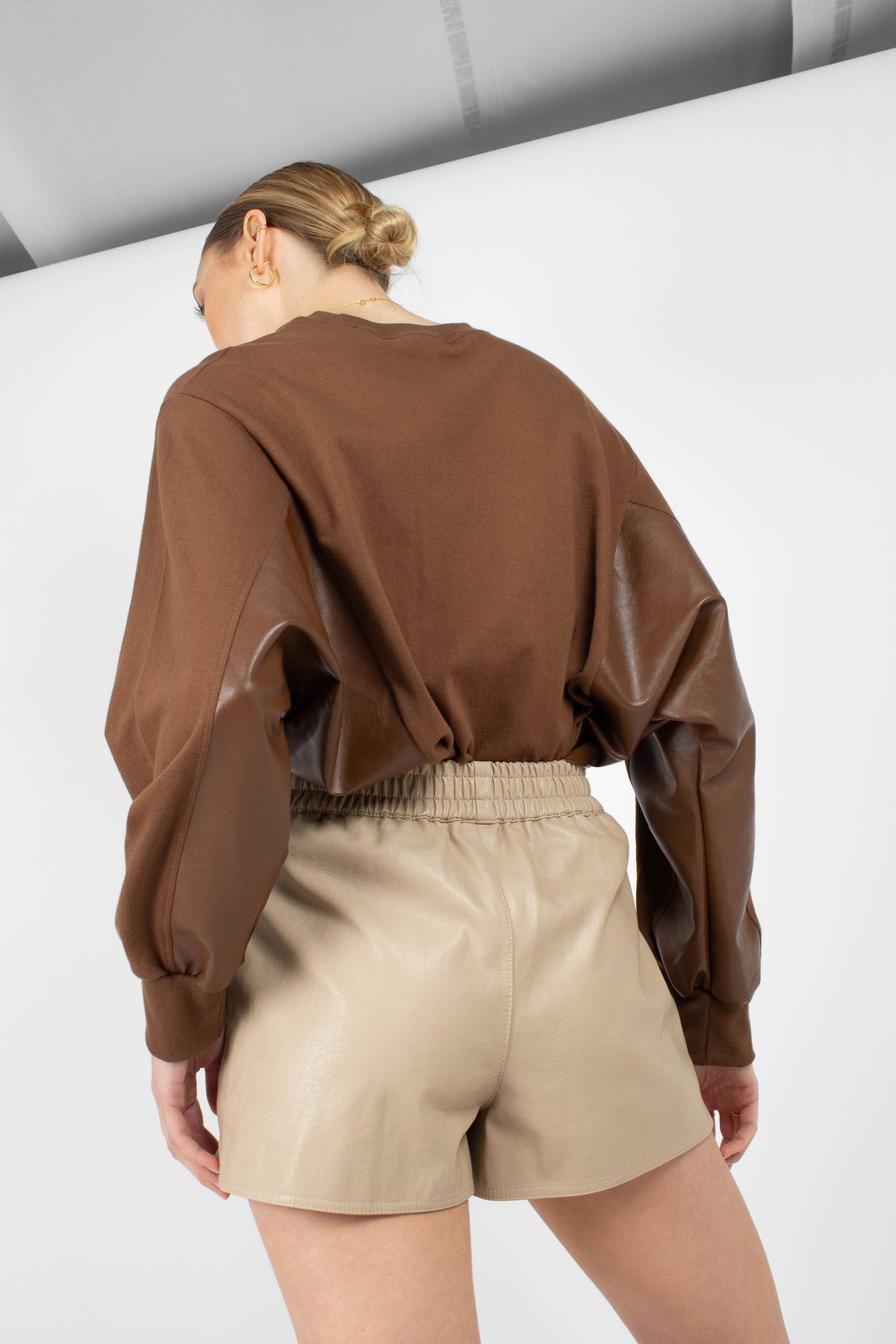 Beige vegan leather running shorts