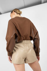 Beige vegan leather running shorts