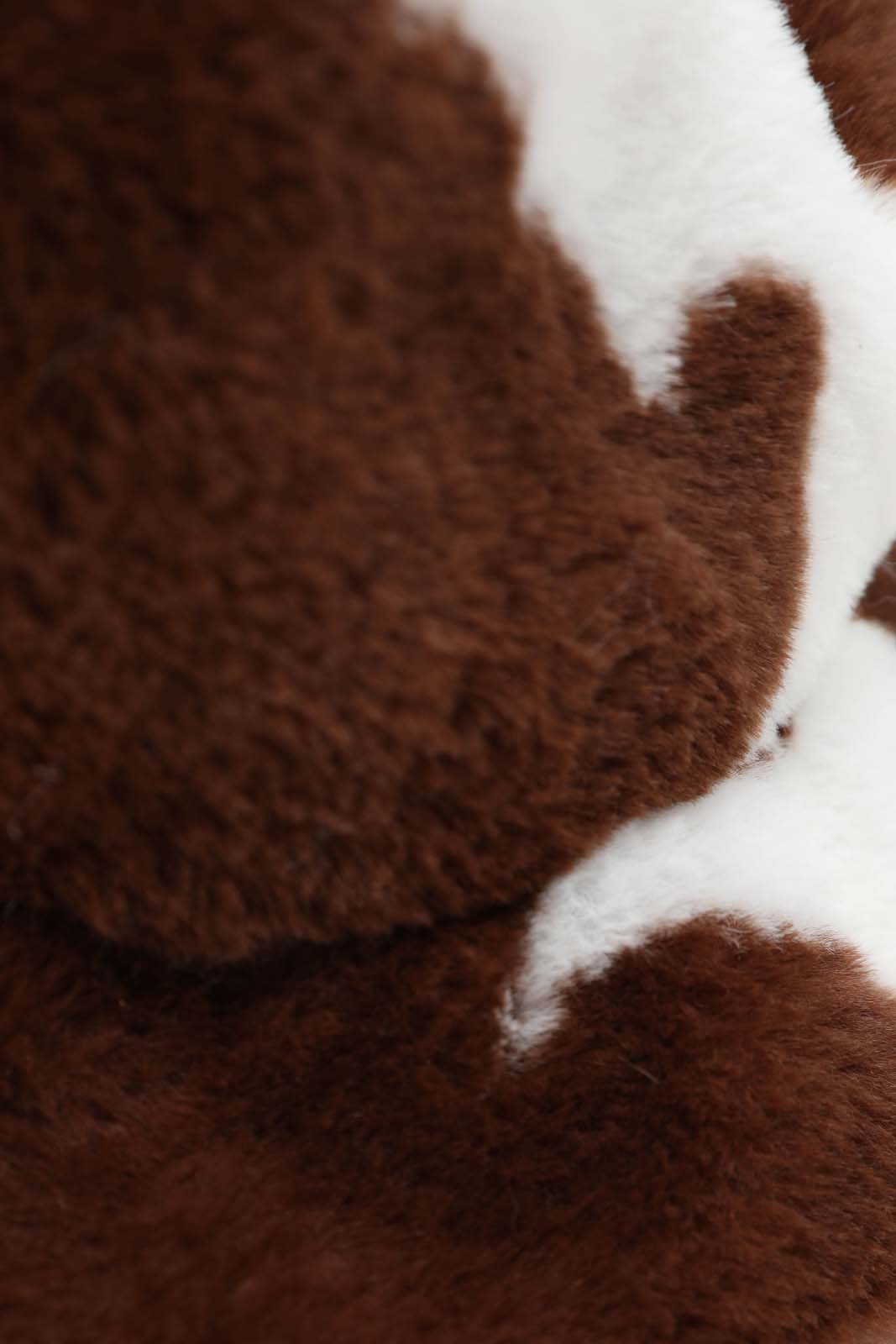 White and brown cow print faux fur bucket hat
