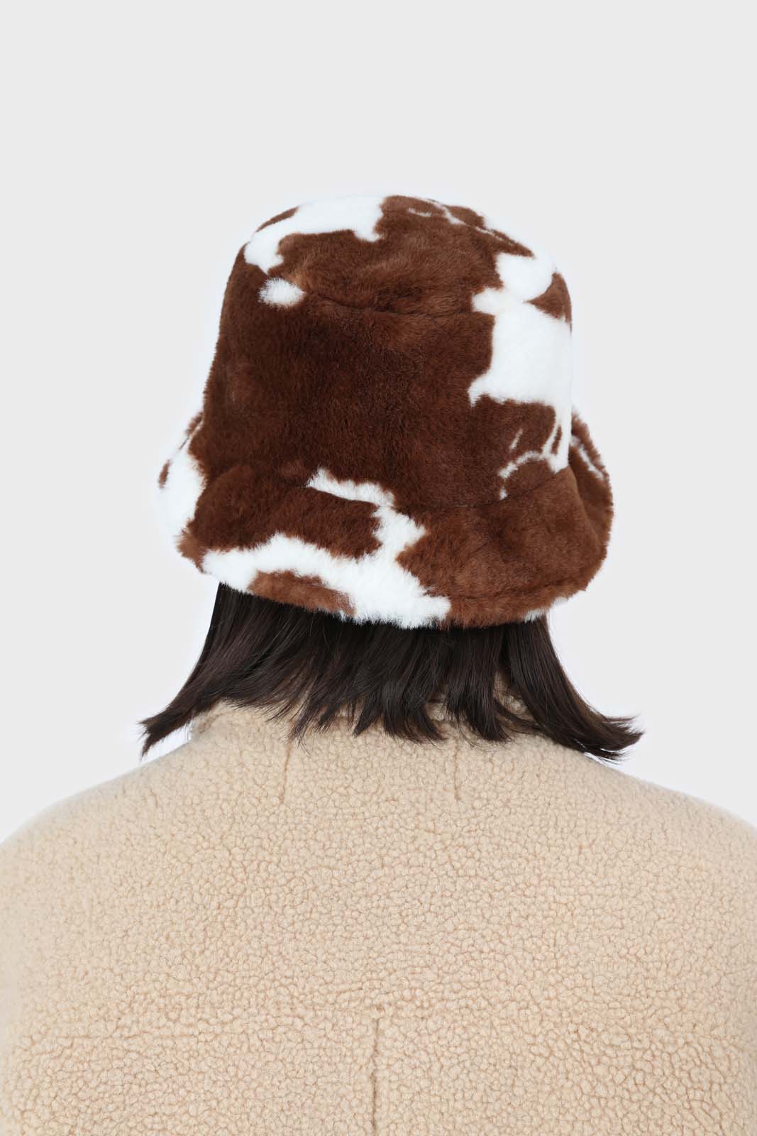 White and brown cow print faux fur bucket hat
