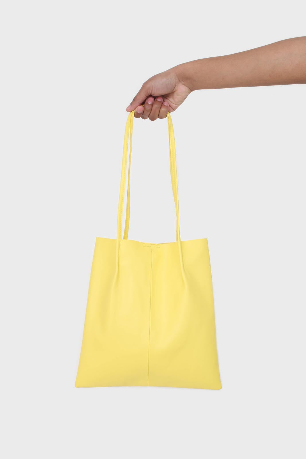 Bright yellow vegan leather pinched strap tote bag