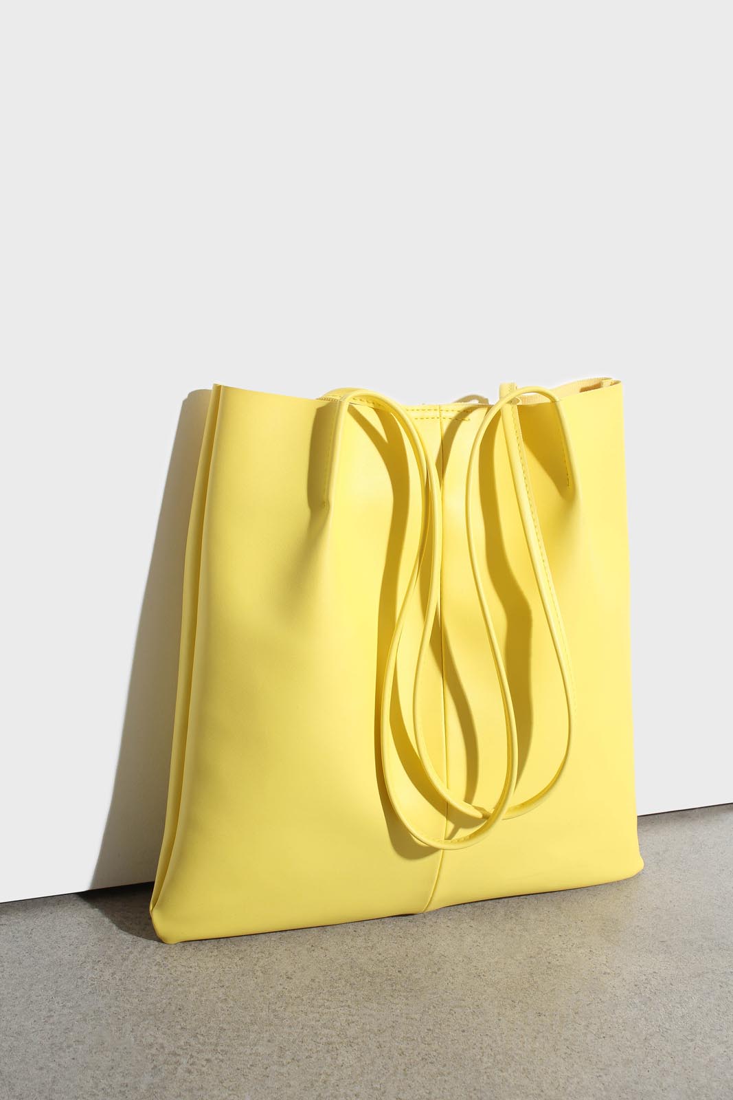 Bright yellow vegan leather pinched strap tote bag