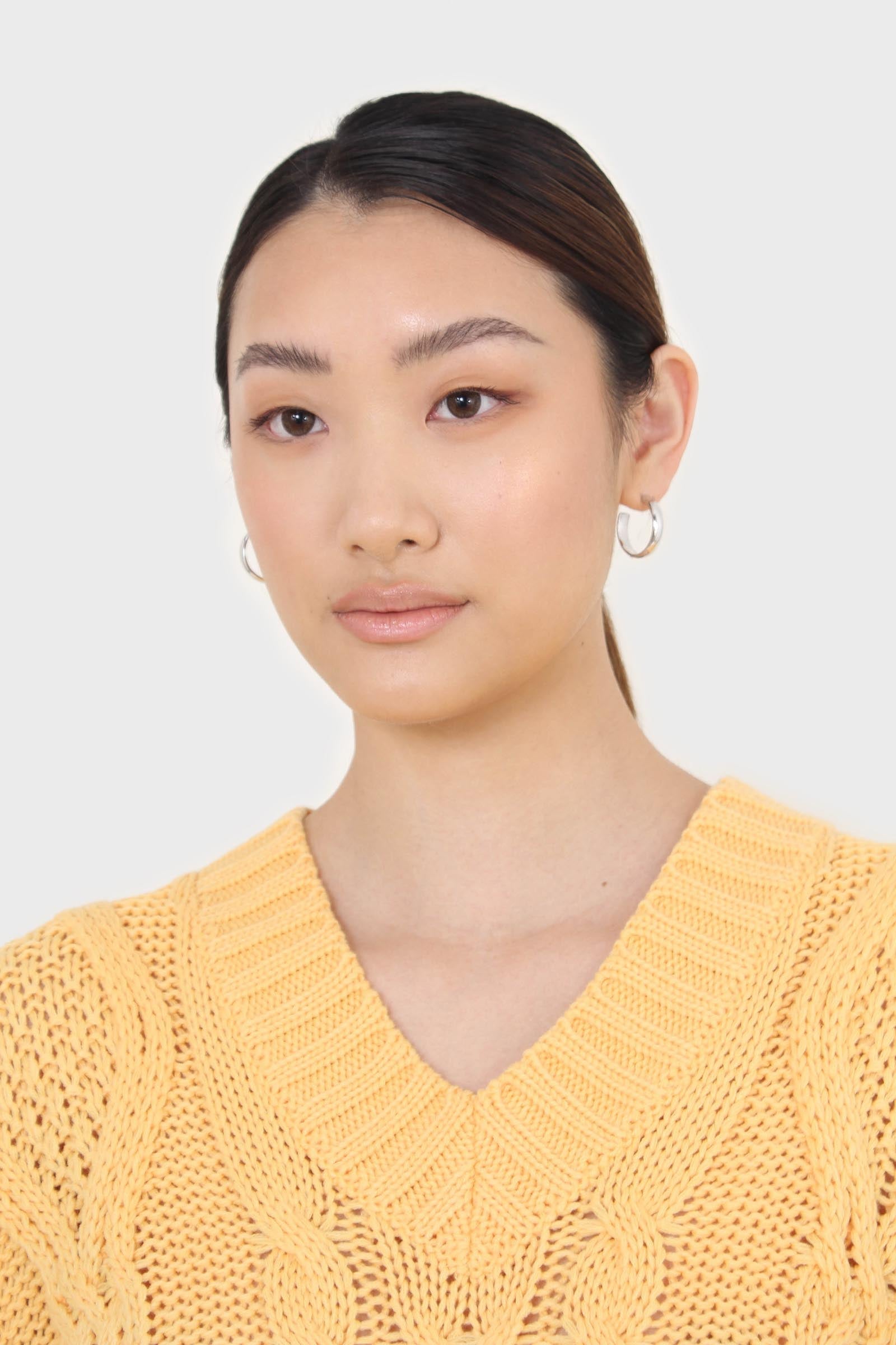 Bright orange cableknit sweater vest