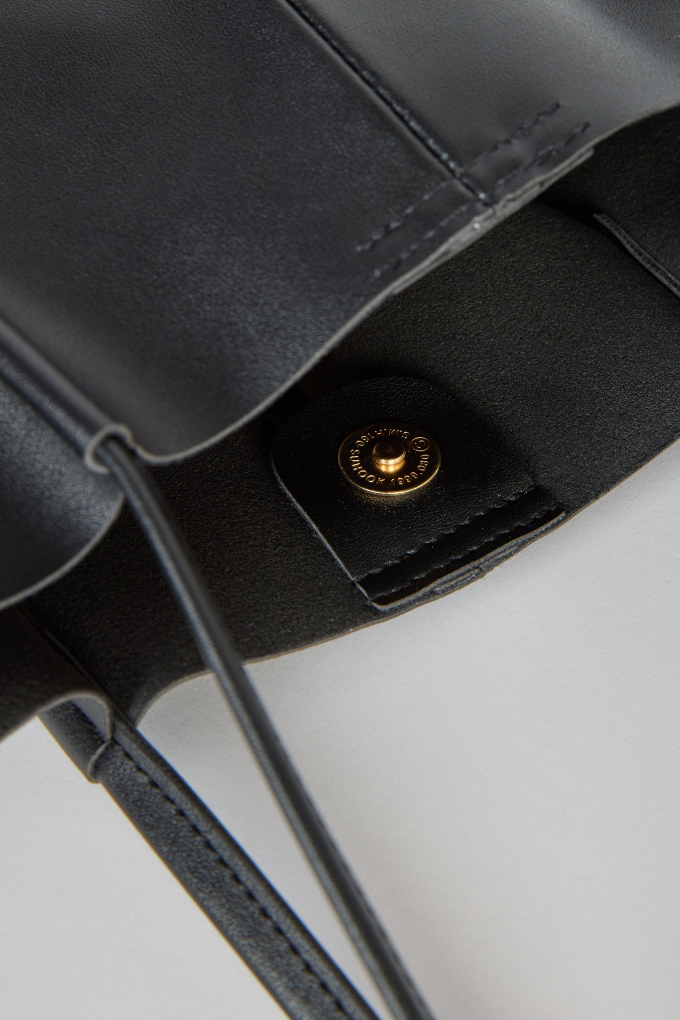 Black vegan leather pinched strap tote bag