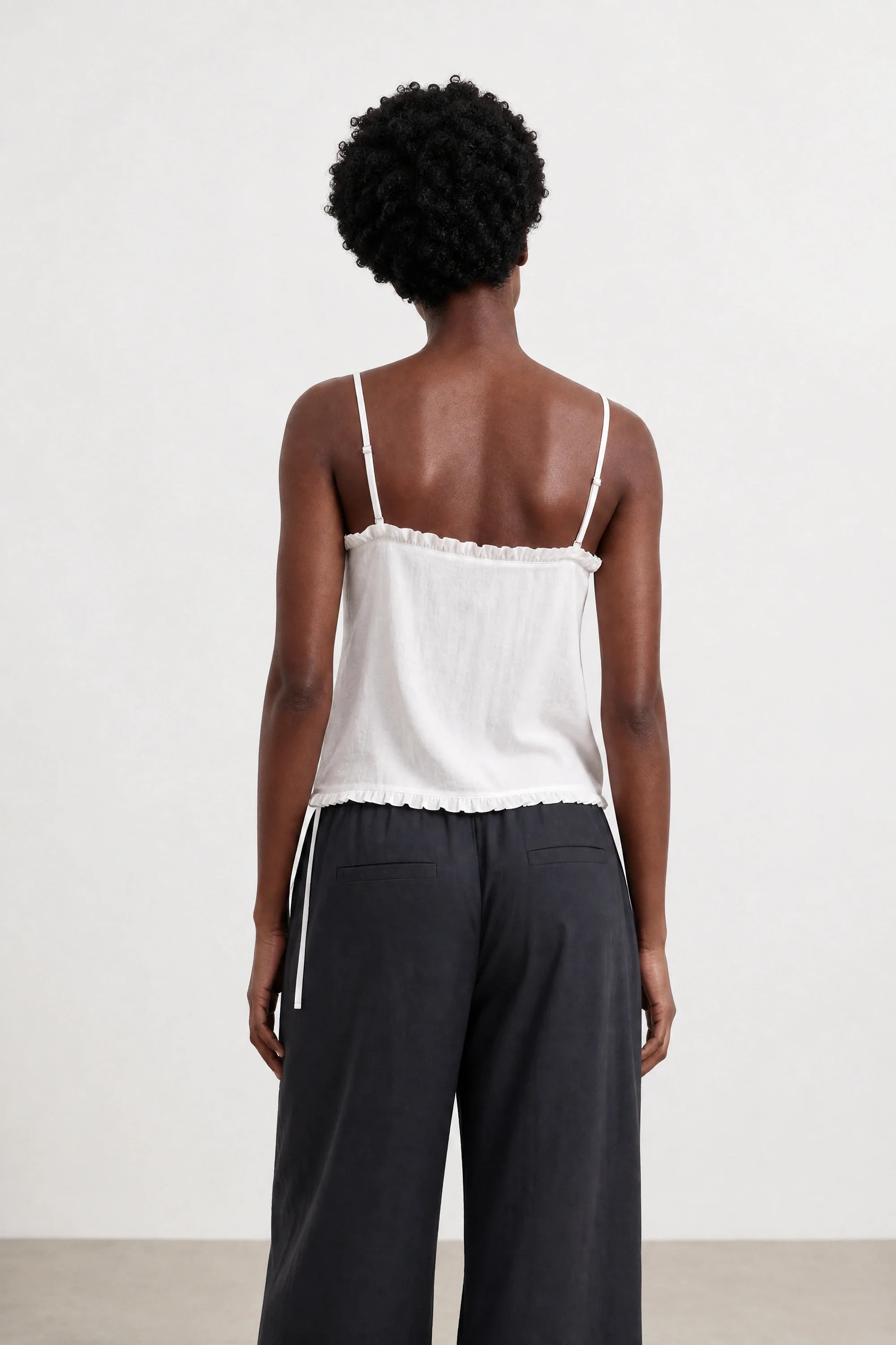 White ruffle trim tie waist tank